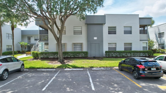 view of property with uncovered parking