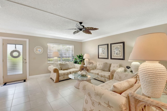 living area featuring light tile patterned flooring, ceiling fan, baseboards, and ornamental molding