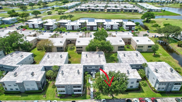 bird's eye view with a water view and view of golf course