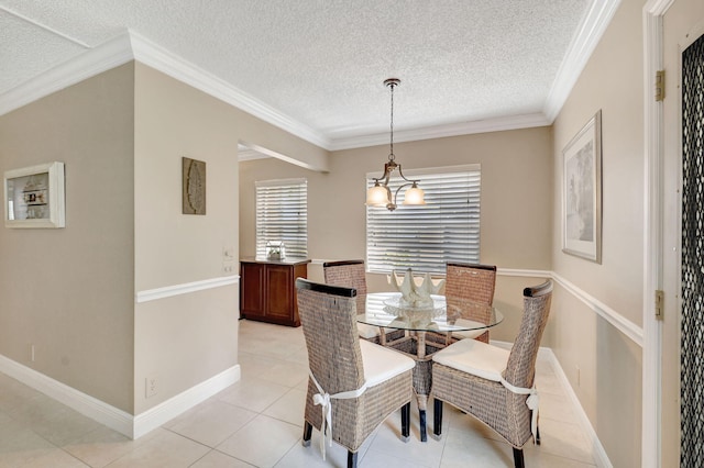 dining space featuring crown molding, baseboards, a textured ceiling, and light tile patterned flooring