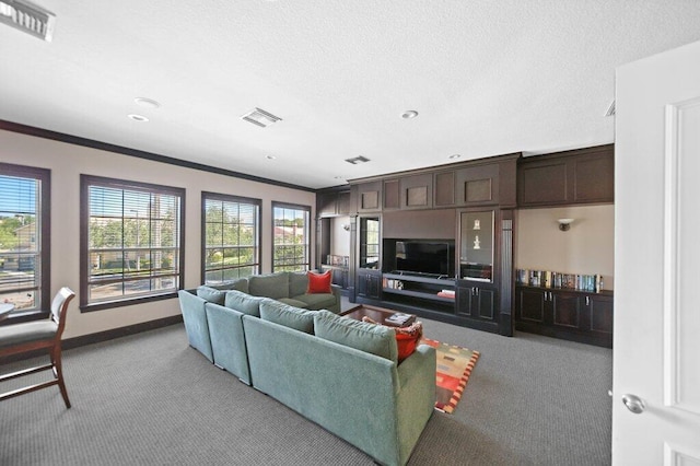 carpeted living room with crown molding, baseboards, plenty of natural light, and visible vents
