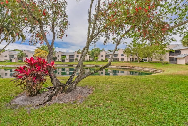 view of yard featuring a water view and a residential view