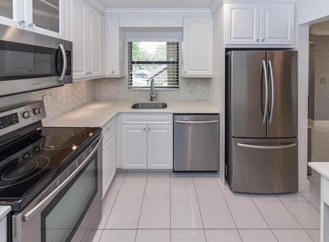 kitchen with light countertops, a sink, white cabinets, and stainless steel appliances