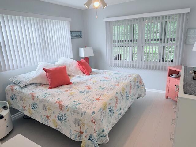 bedroom with wood finished floors and a ceiling fan