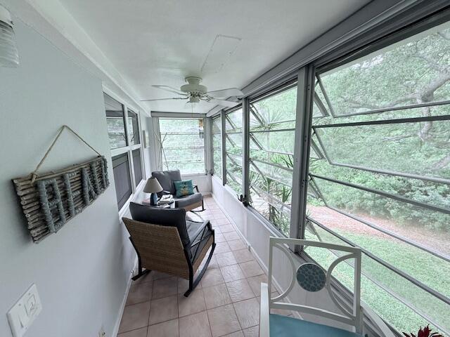 sunroom featuring ceiling fan