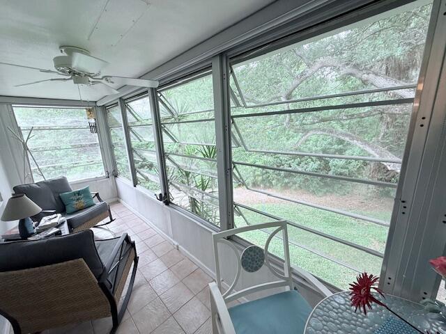 sunroom with a ceiling fan