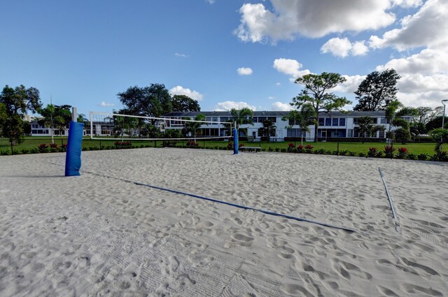 view of home's community with fence and volleyball court