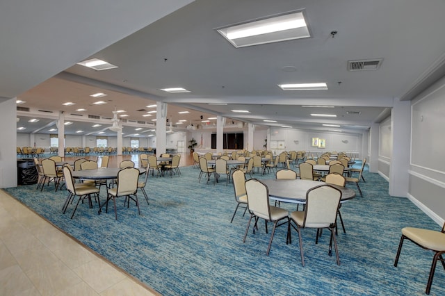 tiled dining room featuring visible vents
