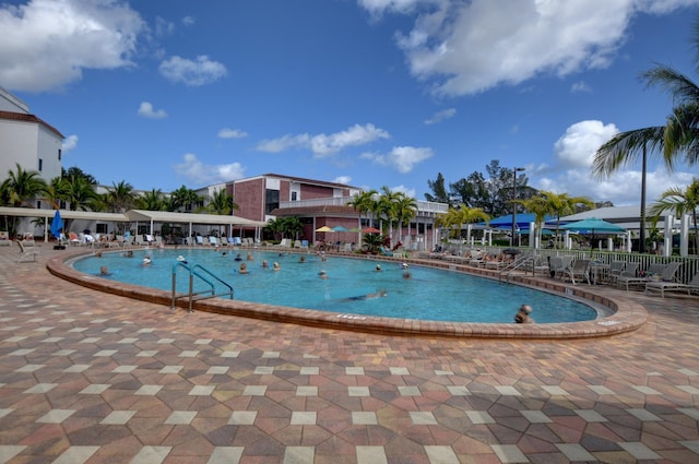 community pool featuring fence and a patio