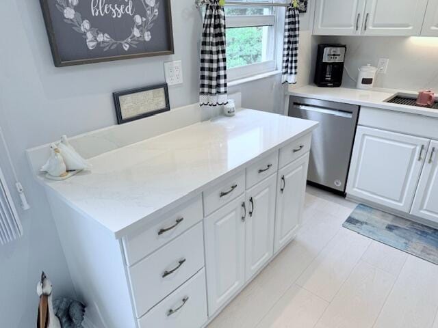 kitchen with dishwasher, light countertops, and white cabinetry
