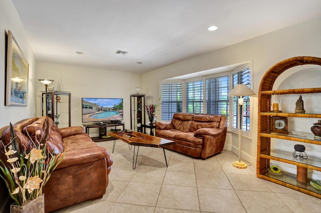 living area with visible vents, recessed lighting, and light tile patterned flooring