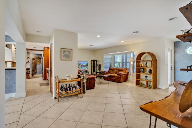 living area featuring light tile patterned floors, baseboards, visible vents, and recessed lighting