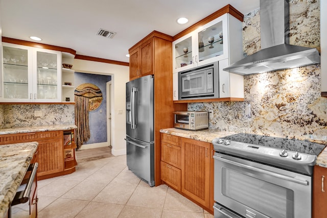 kitchen featuring visible vents, open shelves, wall chimney exhaust hood, stainless steel appliances, and light tile patterned flooring