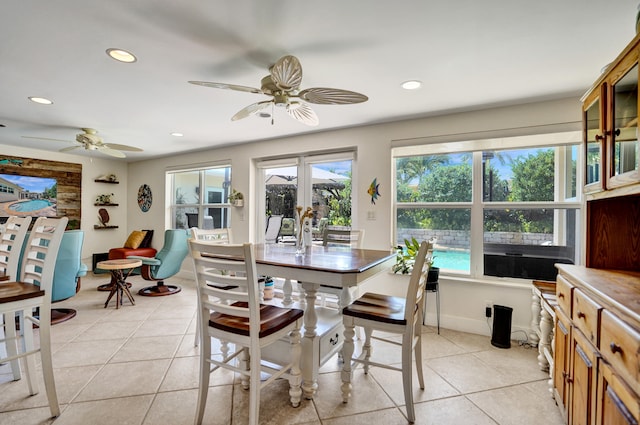 dining area with light tile patterned floors, a ceiling fan, recessed lighting, and a healthy amount of sunlight