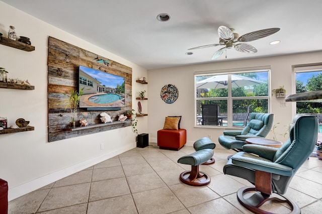 living area with recessed lighting, tile patterned flooring, and a wealth of natural light