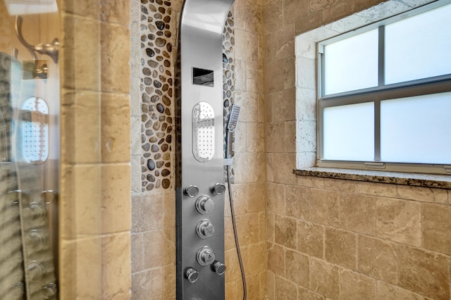 full bath with a tile shower