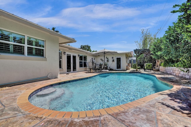 view of pool with a fenced in pool, a patio, a pergola, and french doors