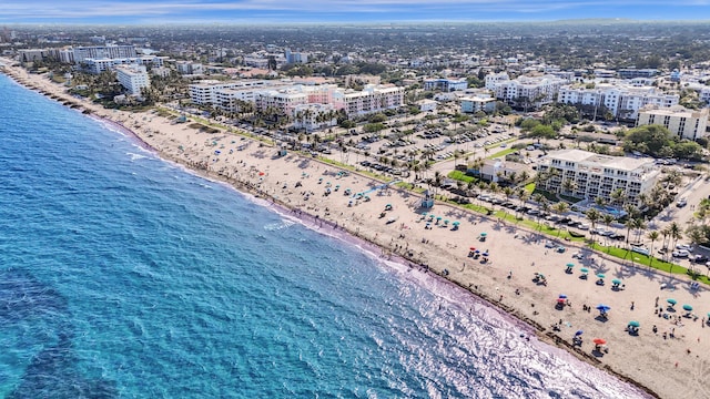 birds eye view of property with a water view, a beach view, and a view of city