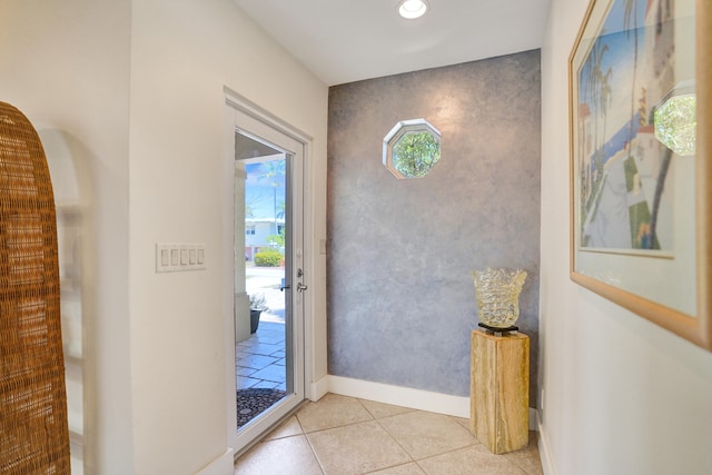 doorway with light tile patterned floors, baseboards, and recessed lighting