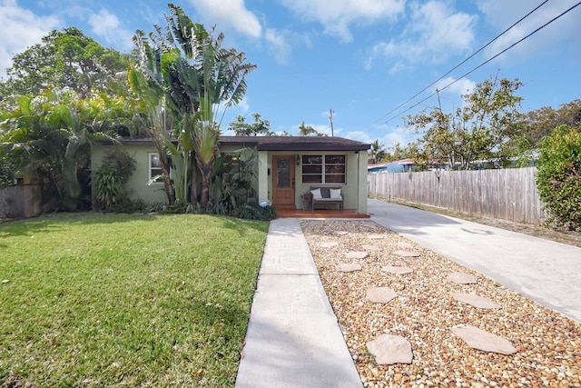 630 Glenridge Dr, West Palm Beach, FL 33405 - view of front of property featuring a front yard, stucco siding, and fence