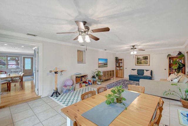 630 Glenridge Dr, West Palm Beach, FL 33405 - dining room with light tile patterned flooring, visible vents, crown molding, and ceiling fan