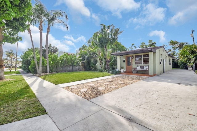 630 Glenridge Dr, West Palm Beach, FL 33405 - view of front of home featuring a front yard, driveway, and stucco siding