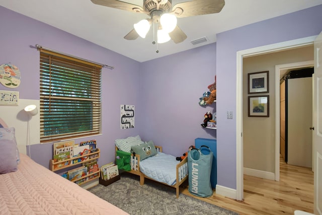 630 Glenridge Dr, West Palm Beach, FL 33405 - bedroom with baseboards, visible vents, a ceiling fan, and wood finished floors
