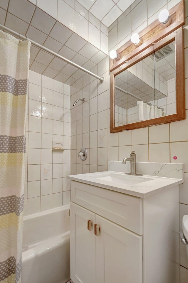 630 Glenridge Dr, West Palm Beach, FL 33405 - full bathroom featuring vanity, shower / bath combination with curtain, decorative backsplash, and tile walls