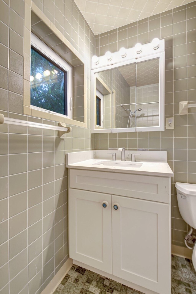 630 Glenridge Dr, West Palm Beach, FL 33405 - bathroom featuring toilet, vanity, and tile walls