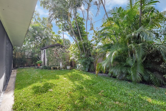 630 Glenridge Dr, West Palm Beach, FL 33405 - view of yard featuring an outbuilding, fence, and a storage shed