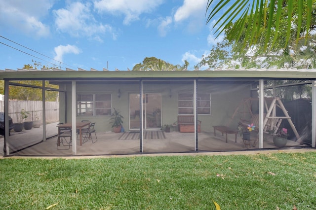 630 Glenridge Dr, West Palm Beach, FL 33405 - back of house with a patio, a sunroom, fence, and a yard