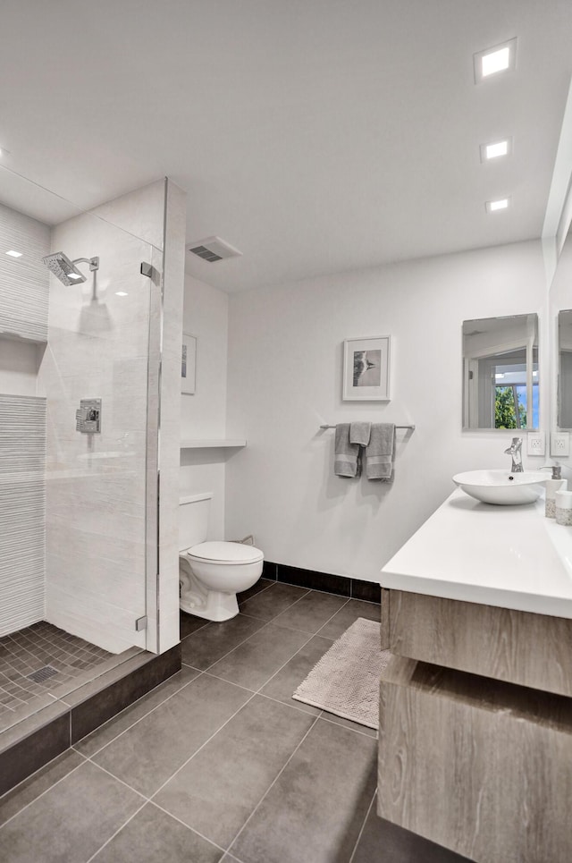 full bath featuring vanity, a tile shower, toilet, tile patterned floors, and visible vents