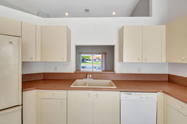 kitchen with recessed lighting, white appliances, cream cabinets, a sink, and visible vents