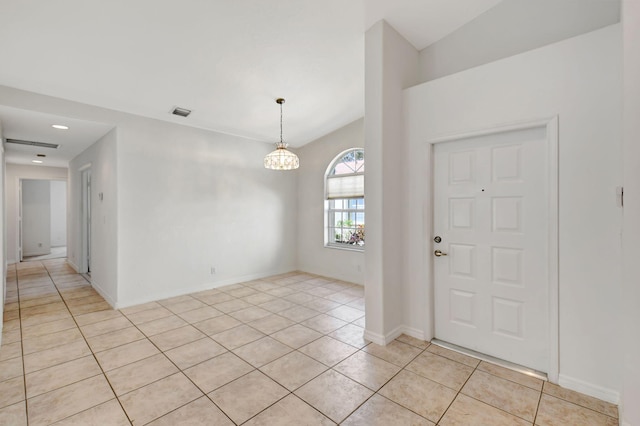 foyer with baseboards, visible vents, an inviting chandelier, and light tile patterned floors