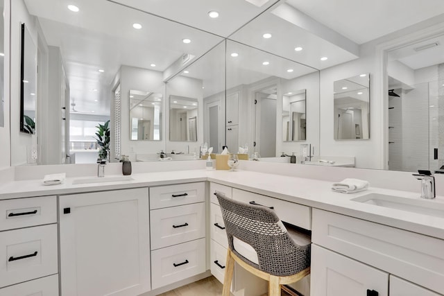 1149 Hillsboro Mile Unit 112N, Hillsboro Beach, FL 33062 - full bathroom with double vanity, a sink, recessed lighting, and a shower stall