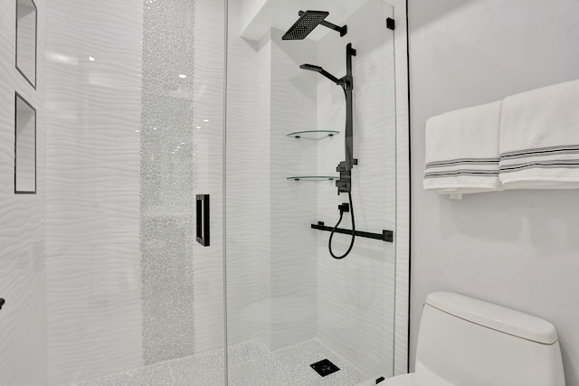 1149 Hillsboro Mile Unit 112N, Hillsboro Beach, FL 33062 - bathroom featuring toilet and a shower stall