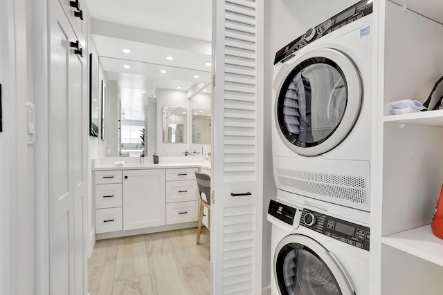 1149 Hillsboro Mile Unit 112N, Hillsboro Beach, FL 33062 - washroom featuring stacked washer / drying machine, laundry area, and recessed lighting