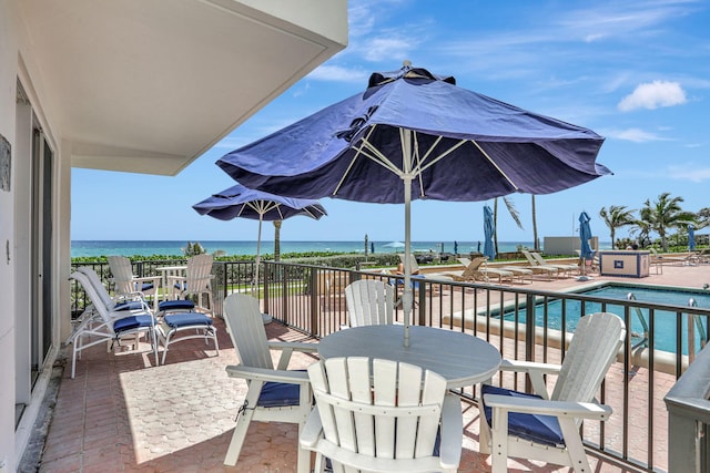 1149 Hillsboro Mile Unit 112N, Hillsboro Beach, FL 33062 - view of patio / terrace with a community pool and a water view