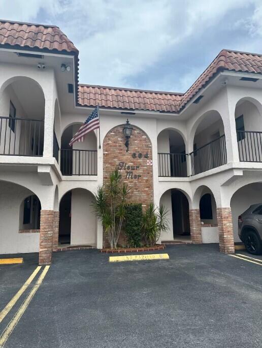 664 SE 20th Ave Unit 1, Deerfield Beach, FL 33441 - view of building exterior with uncovered parking