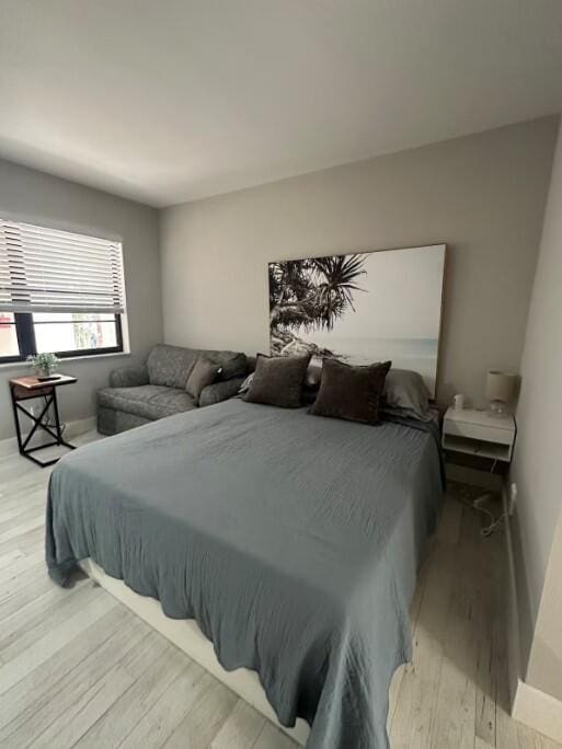 664 SE 20th Ave Unit 1, Deerfield Beach, FL 33441 - bedroom with baseboards and light wood-style flooring