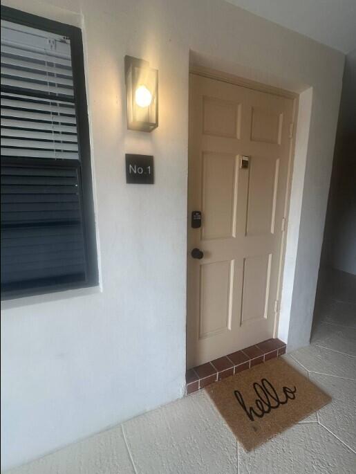 664 SE 20th Ave Unit 1, Deerfield Beach, FL 33441 - doorway to property featuring stucco siding
