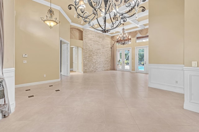 11604 Kensington Ct, Boca Raton, FL 33428 - unfurnished room with crown molding, a chandelier, light tile patterned floors, a towering ceiling, and coffered ceiling