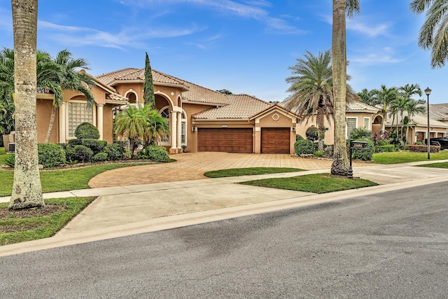 11604 Kensington Ct, Boca Raton, FL 33428 - mediterranean / spanish-style house with a tiled roof, stucco siding, an attached garage, and decorative driveway