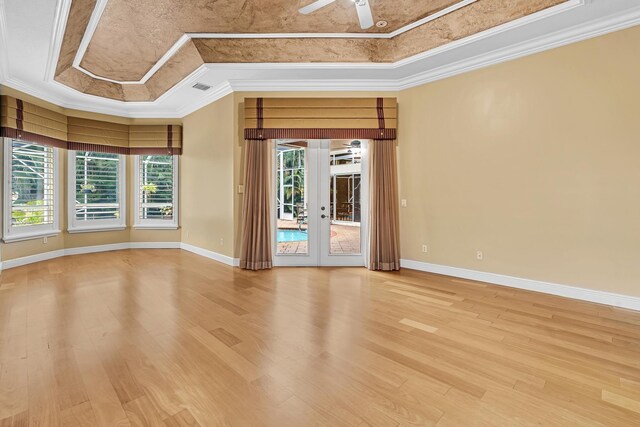 11604 Kensington Ct, Boca Raton, FL 33428 - empty room with ceiling fan, ornamental molding, a tray ceiling, and light wood-type flooring