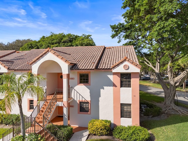 301 Norwood Ter Unit N230, Boca Raton, FL 33431 - view of front of house featuring stucco siding, stairs, and a tiled roof