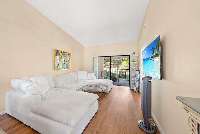 301 Norwood Ter Unit N230, Boca Raton, FL 33431 - living area featuring baseboards, vaulted ceiling, and light wood-type flooring