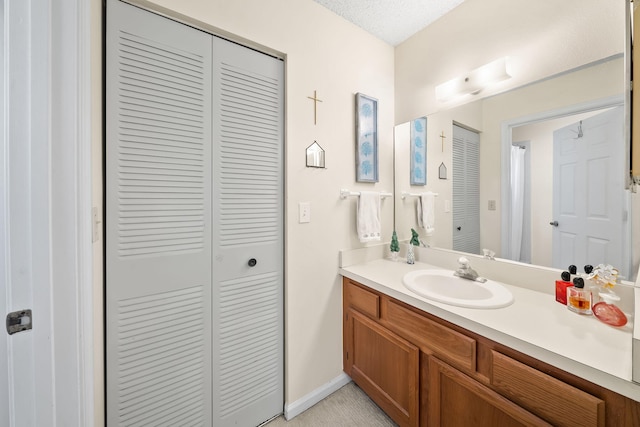 301 Norwood Ter Unit N230, Boca Raton, FL 33431 - full bath with vanity, baseboards, a closet, and a textured ceiling