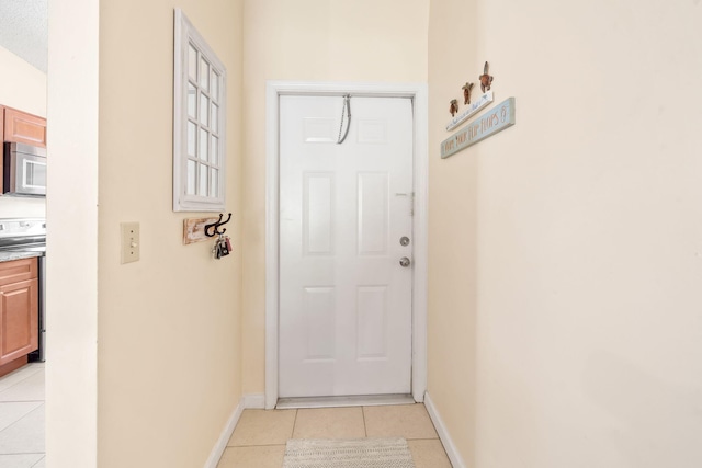 301 Norwood Ter Unit N230, Boca Raton, FL 33431 - entryway with light tile patterned flooring and baseboards