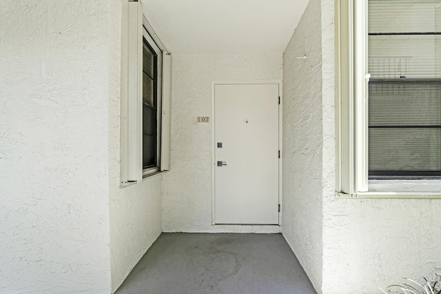 1555 S Federal Hwy Unit 107, Delray Beach, FL 33483 - doorway to property with stucco siding