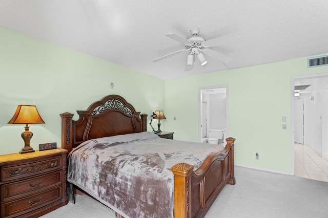 bedroom featuring light colored carpet, baseboards, connected bathroom, ceiling fan, and visible vents